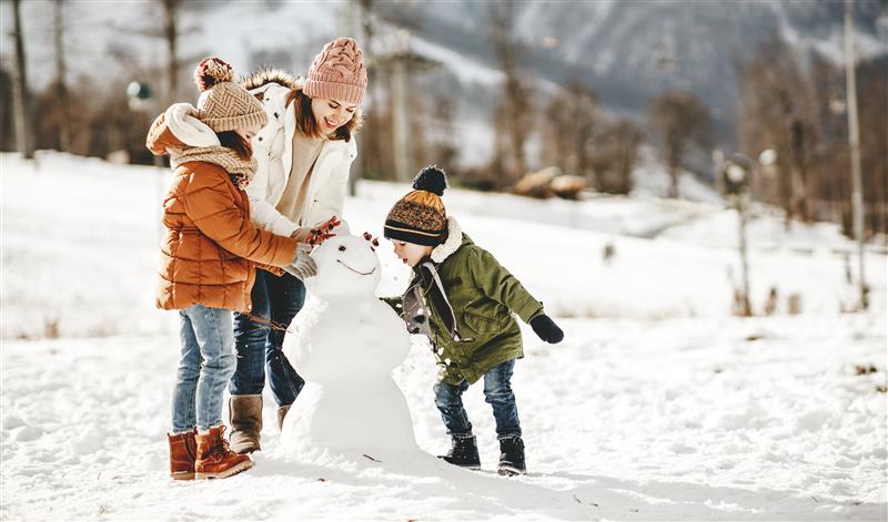 Image of a family building a snowman
